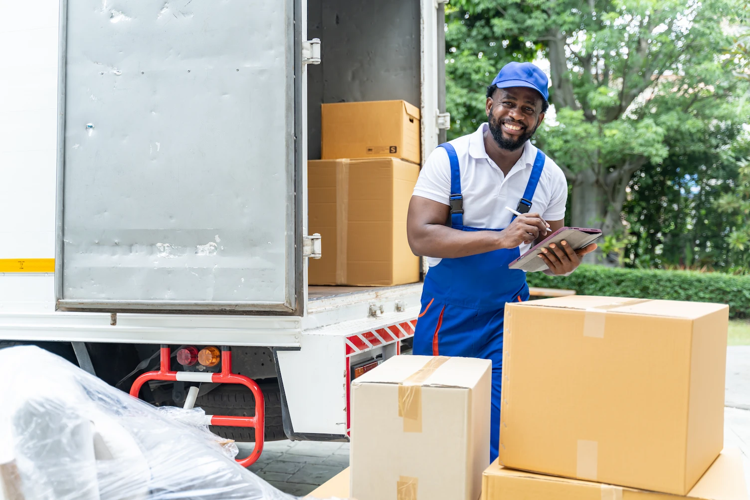 Delivery professional with packages at a truck